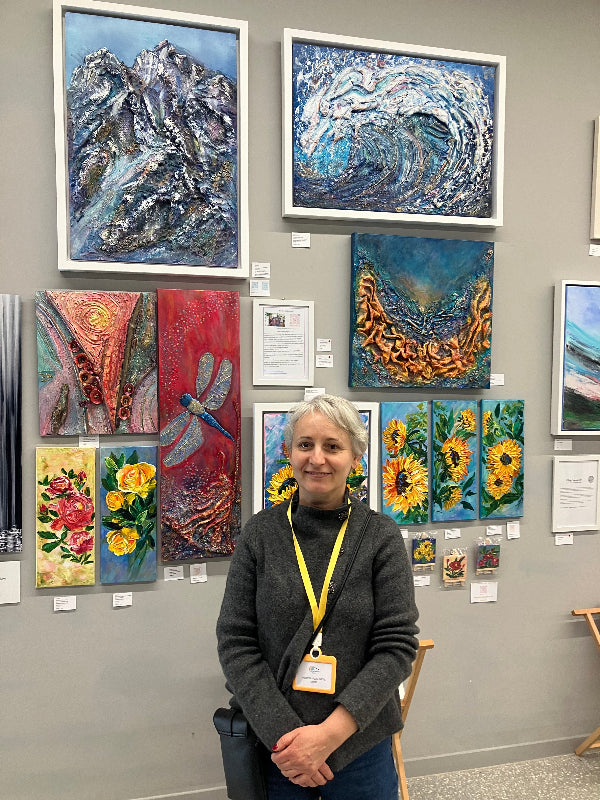 Aferdita and her art work at the Under The Rainbow Exhibition of Uplifting Art in Bluewater