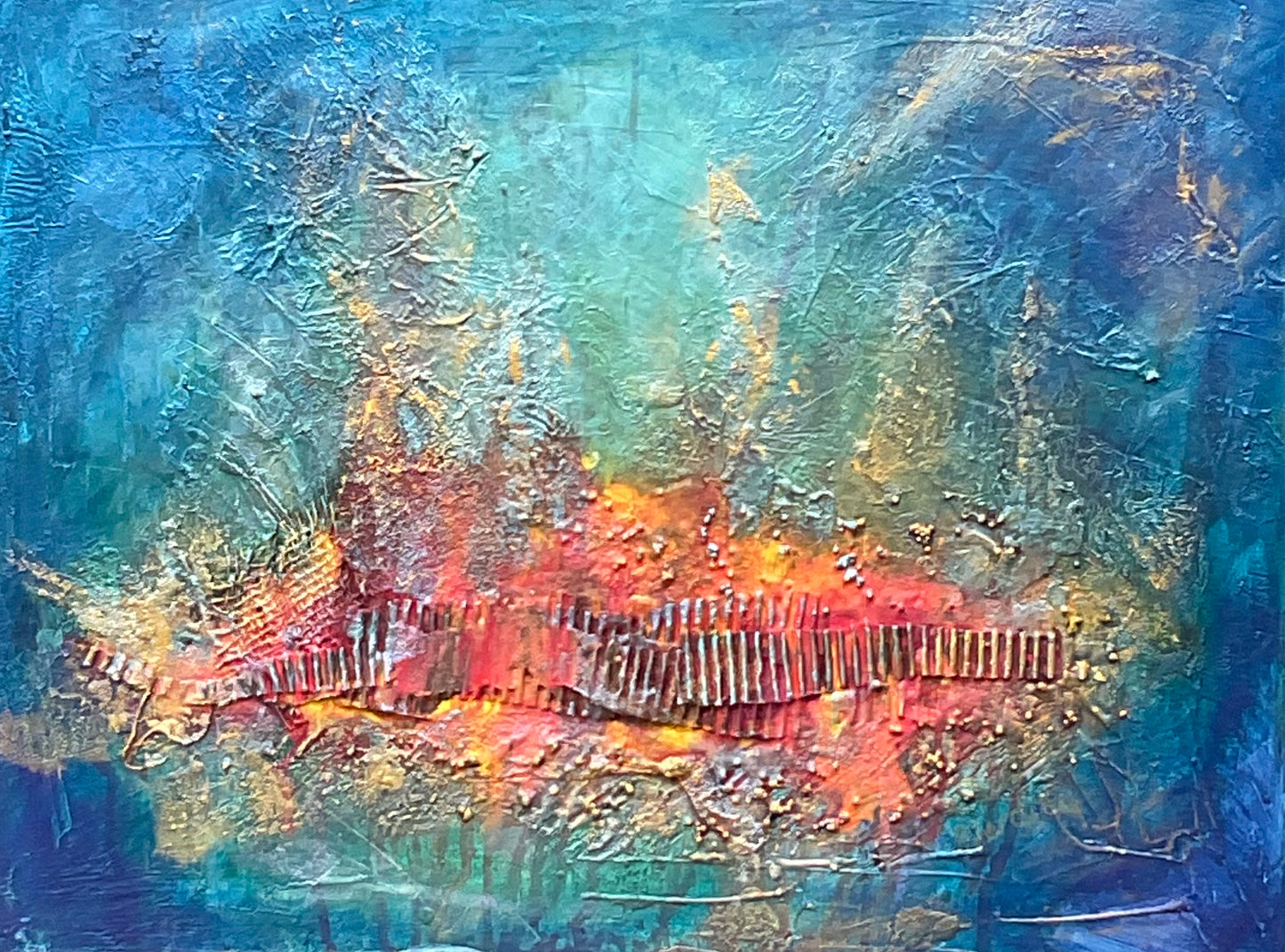 mixed media with a red / orange and gold textured focal point surrounded with a blue turquoise background.