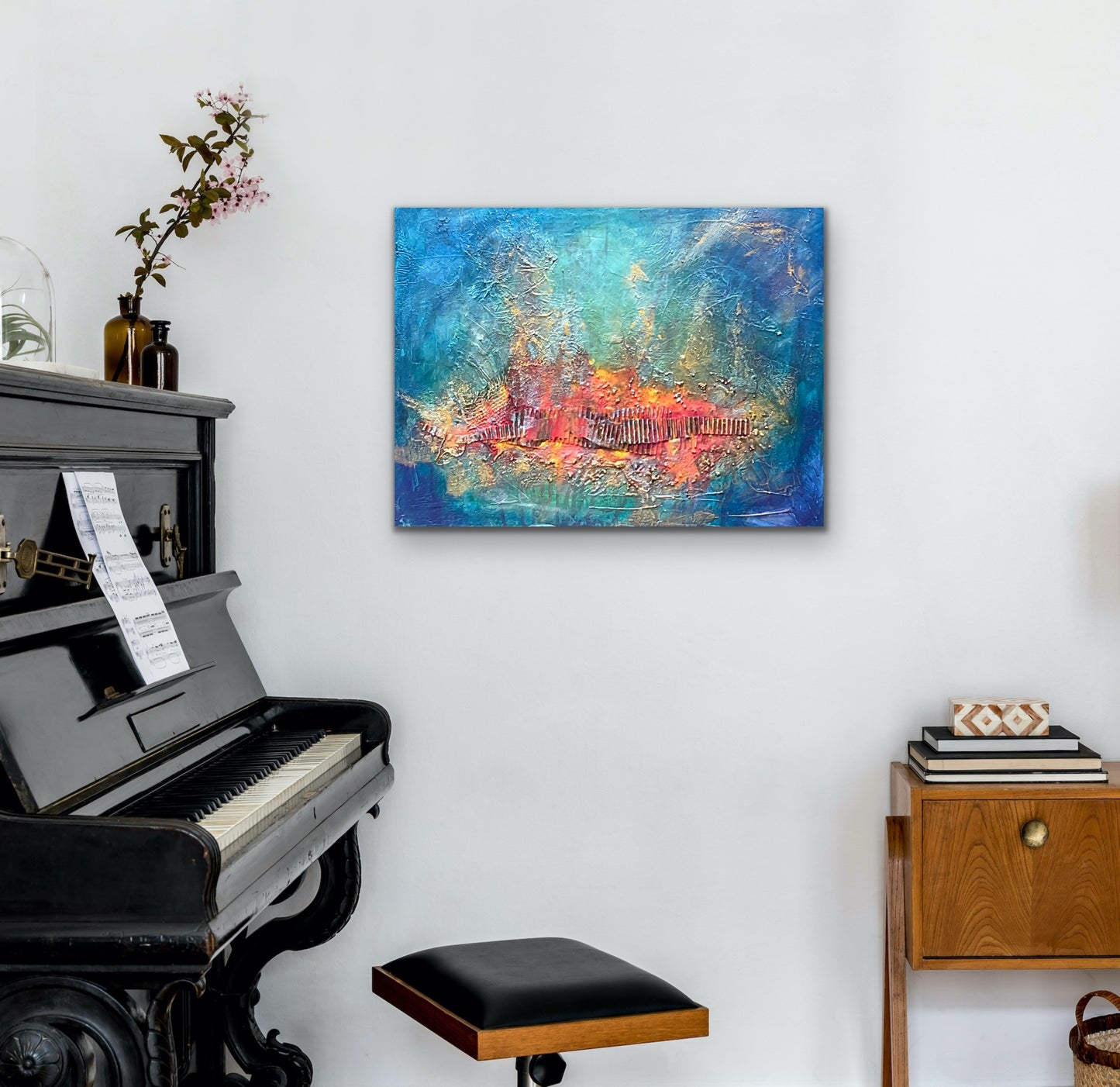 mixed media with a red / orange and gold textured focal point surrounded with a blue turquoise background.