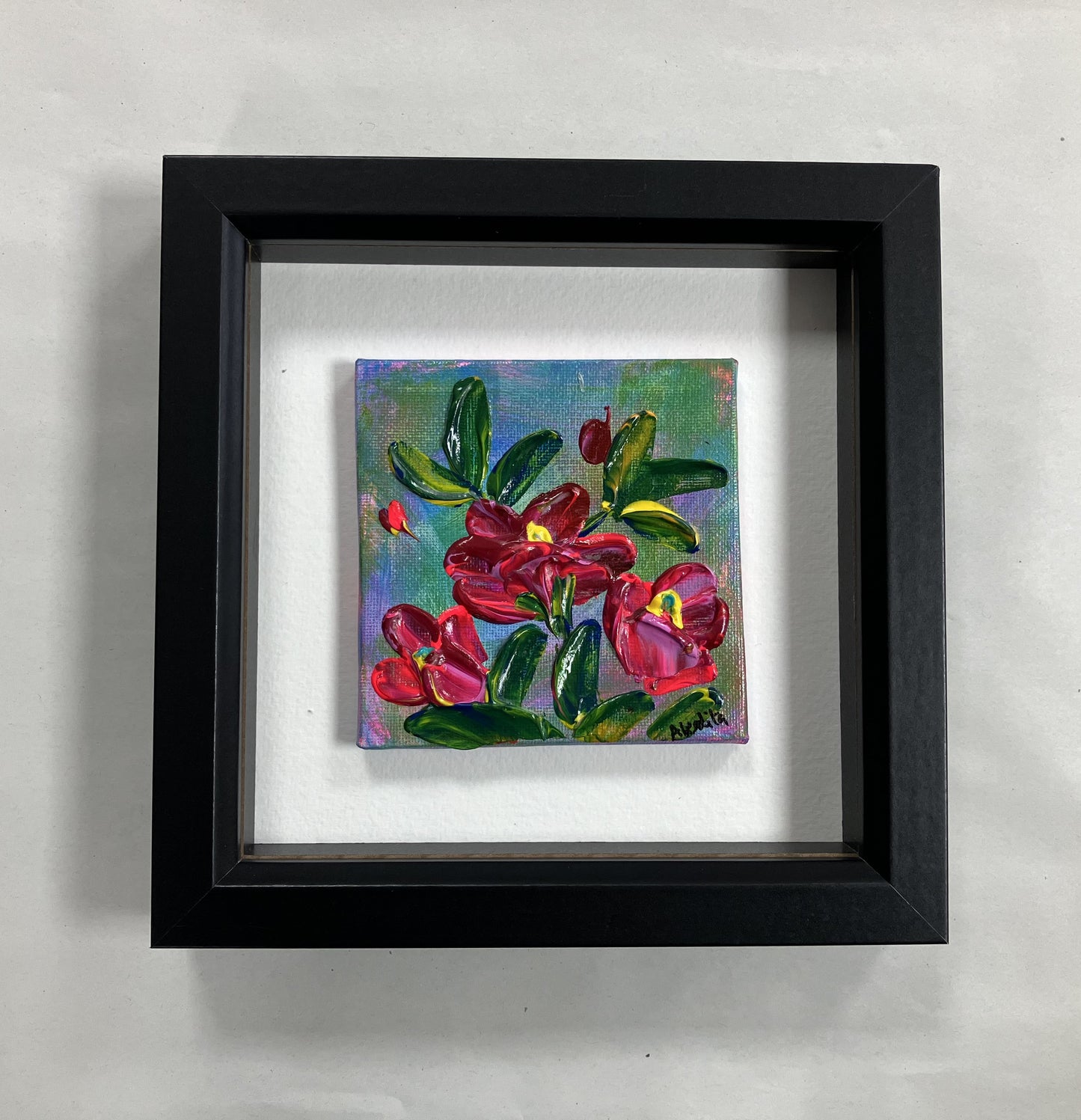red flowers on a blue green background framed