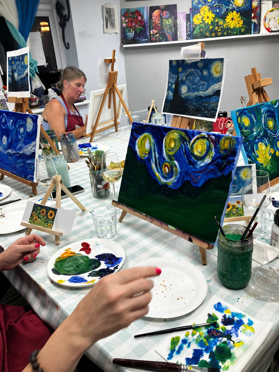 Artistic workspace with paintings and an artist at work PAINTING STARRY NIGHT 