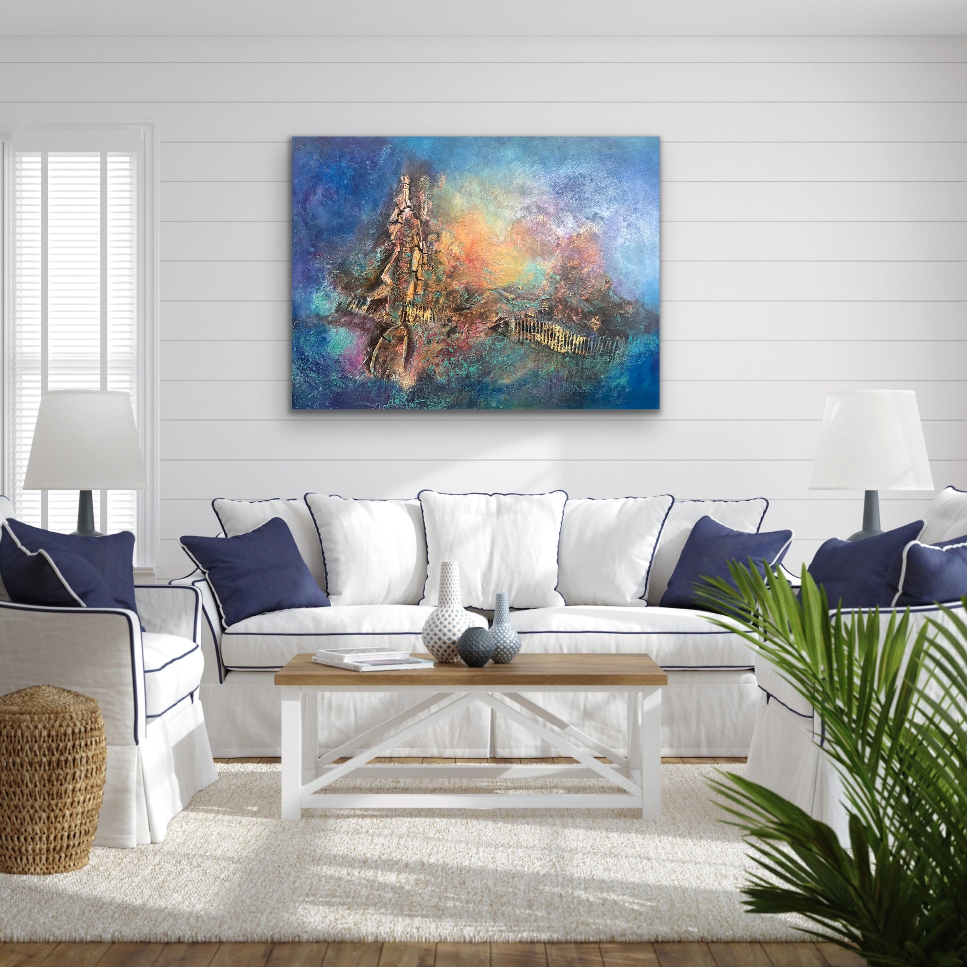 abstract textured artwork with blue backgound and warm colours of red and yellows and golds 